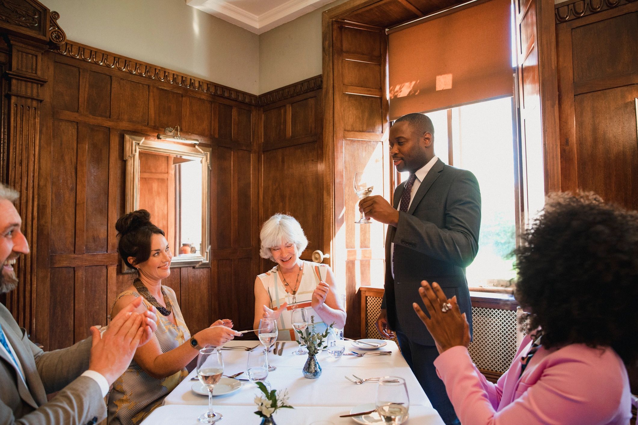 Friends gathered around a luxury dinner table during an upscale event
